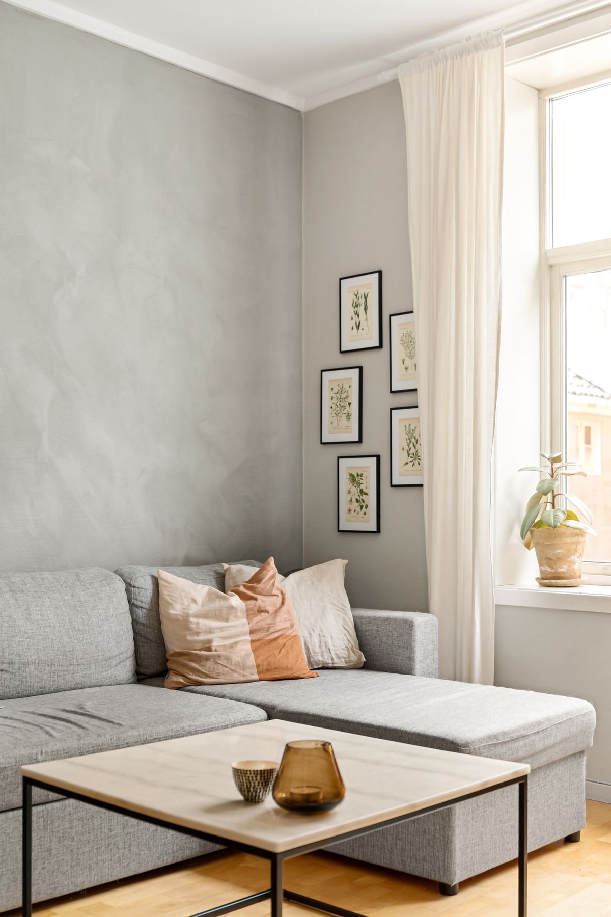 A calm, sunlit living room with soft furnishings
